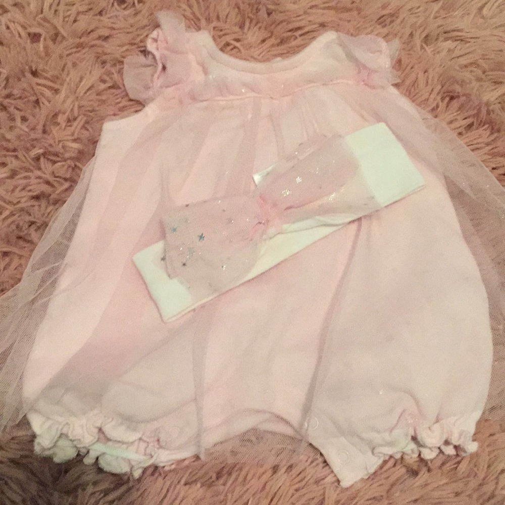 Infant romper with matching bow.